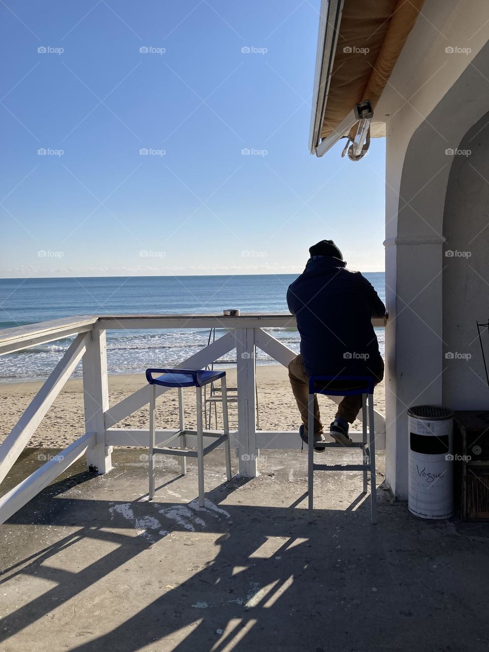 Man sitting on a chair and watching the beautiful sea view 