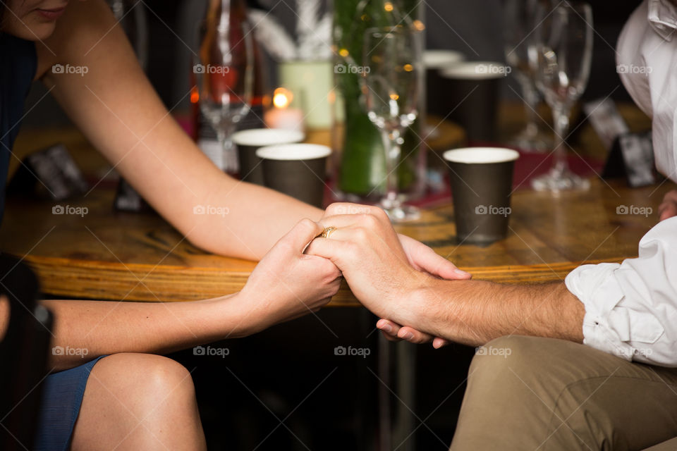 My favourite moment is when you can see people are in love. Image of couple holding hands at a table