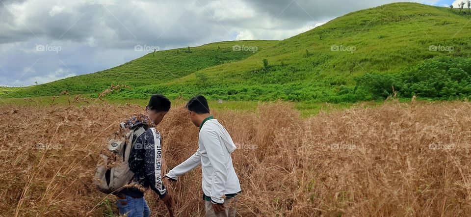 The meadow, the hills and the sky are beautiful