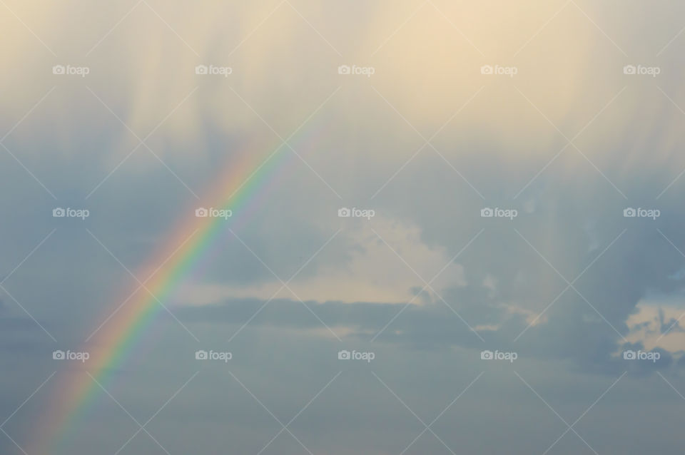 Dreamlike rainbow in sky with different kinds of clouds beautiful cloudscape and nature landscape photography 