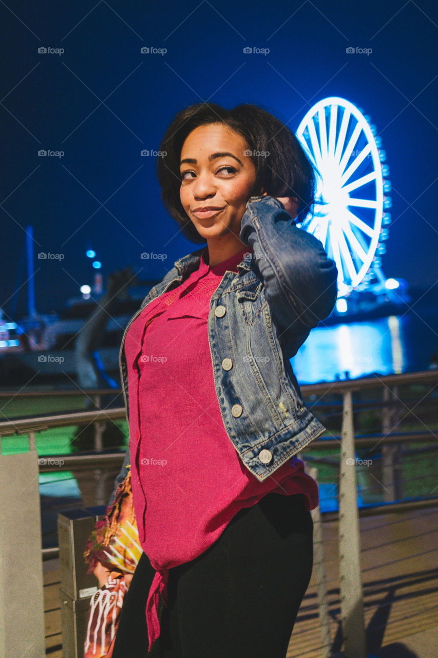 African woman standing near the pier