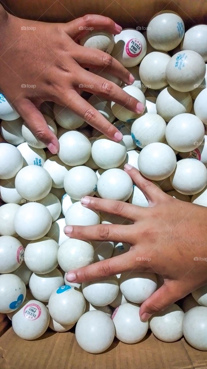 hands between ping pong balls
