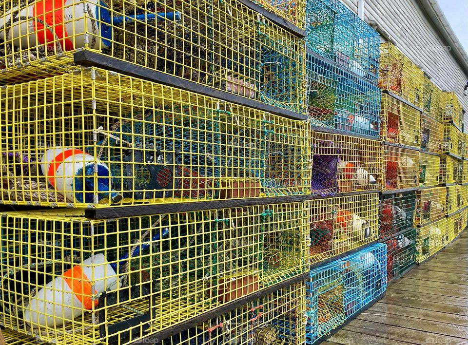 “Rainy Day stacks.” Colorful lobster traps line a wharf.