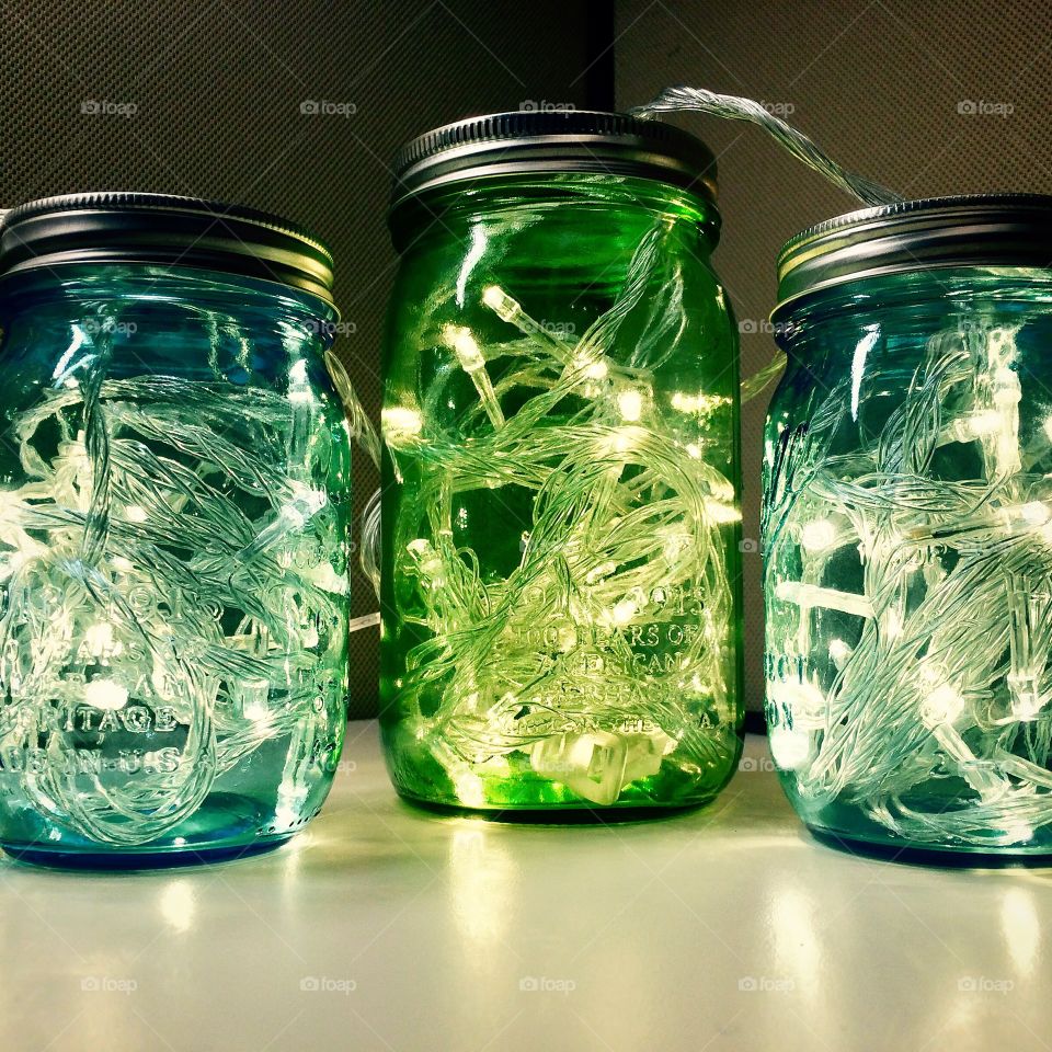 Mason Jar Decoration. Christmas lights through colored mason jars!