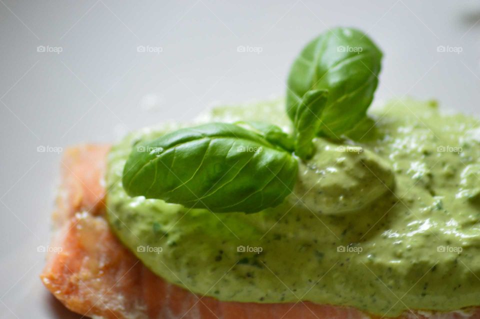 Fresh healthy salmon in basil sauce