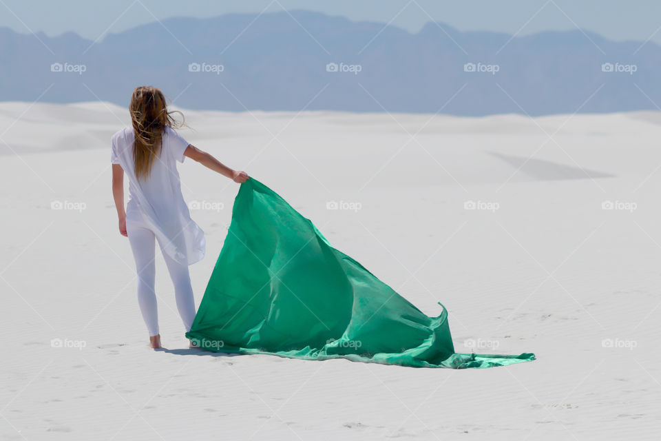 Rear view of a woman holding textile