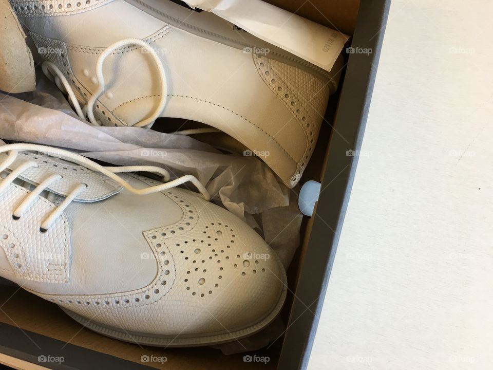 White vintage style sport golf sneakers in a box 