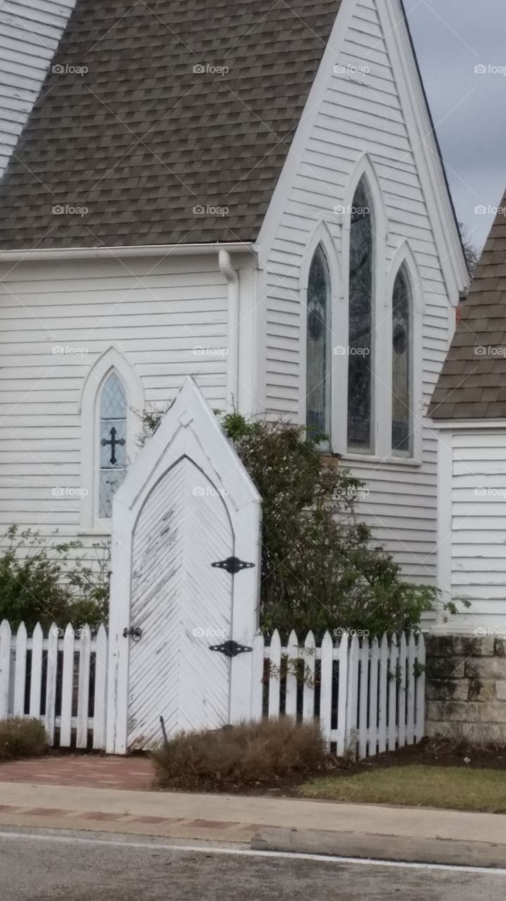 Gothic church with white fence and gate