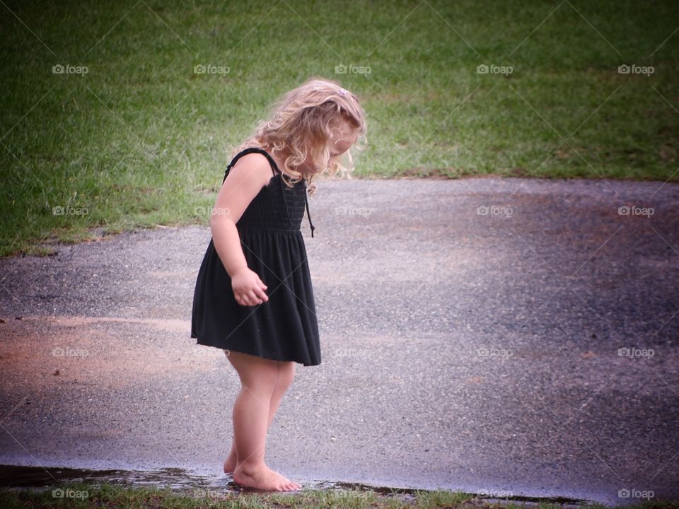 Little girl playing in the water 