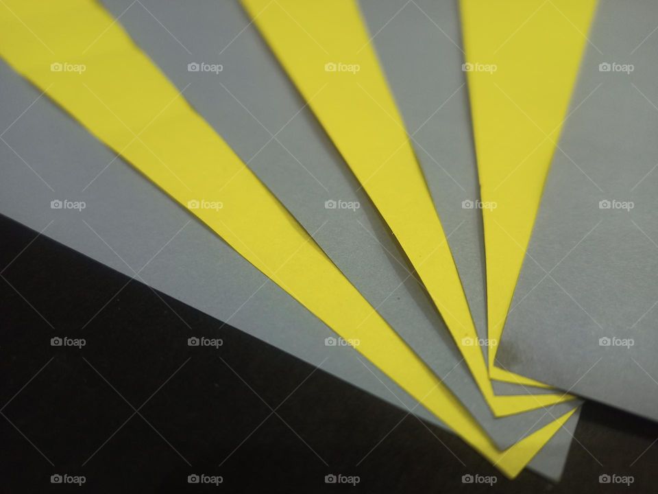 Display of yellow grey origami papers on a black 🖤 background