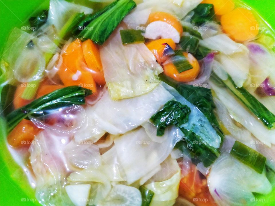 Simple vegetable soup, carrots, cabbage, mustard greens, green onions, celery.  vegetable backgrounds