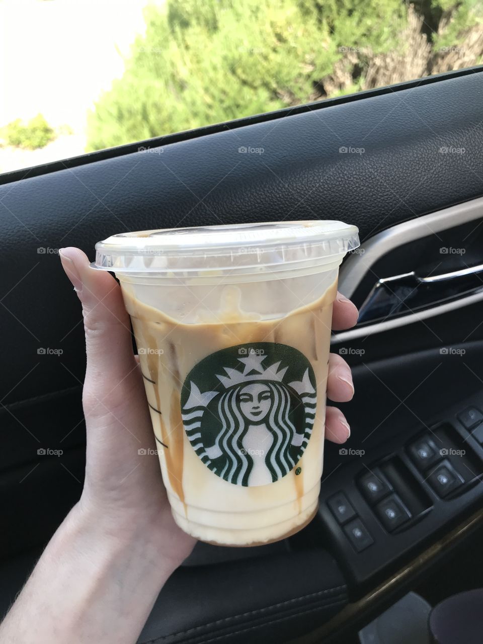 Holding a Starbucks coffee drink in hand - caramel Frappuccino 