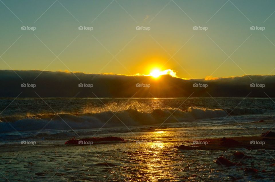 Crashing Sunset. Sun rays peaked out meeting the crashing waves in its final moments of the day. ~Jalama Beach, CA