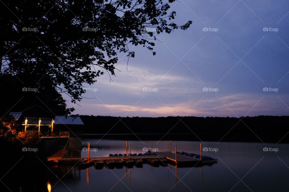 Foap, Light: Natural vs Artificial - A dock illuminated by the lights from the boathouse during early morning twilight at Lake Johnson in Raleigh North Carolina. 