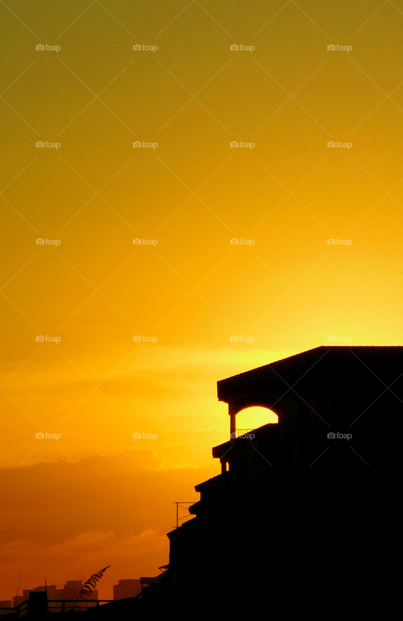 Silhouette of building at sunset