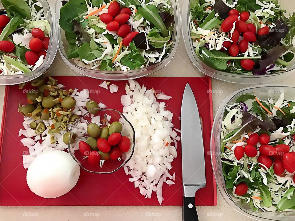 Preparing multiple multicolored salads.