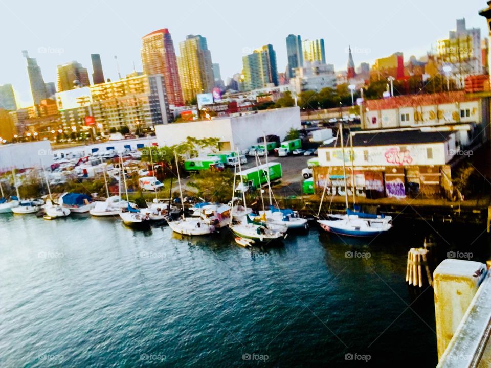 The waters of the East River at Newtown Creek with all its boats as seen from atop the Pulaski Bridge in Long Island City, Queens, NY on a summertime afternoon in 2019. Hypnotic Productions