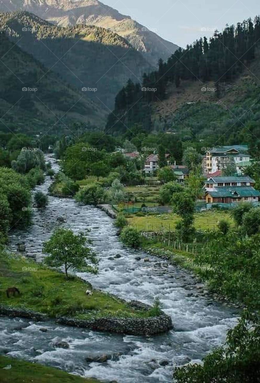 river between village and mountain
