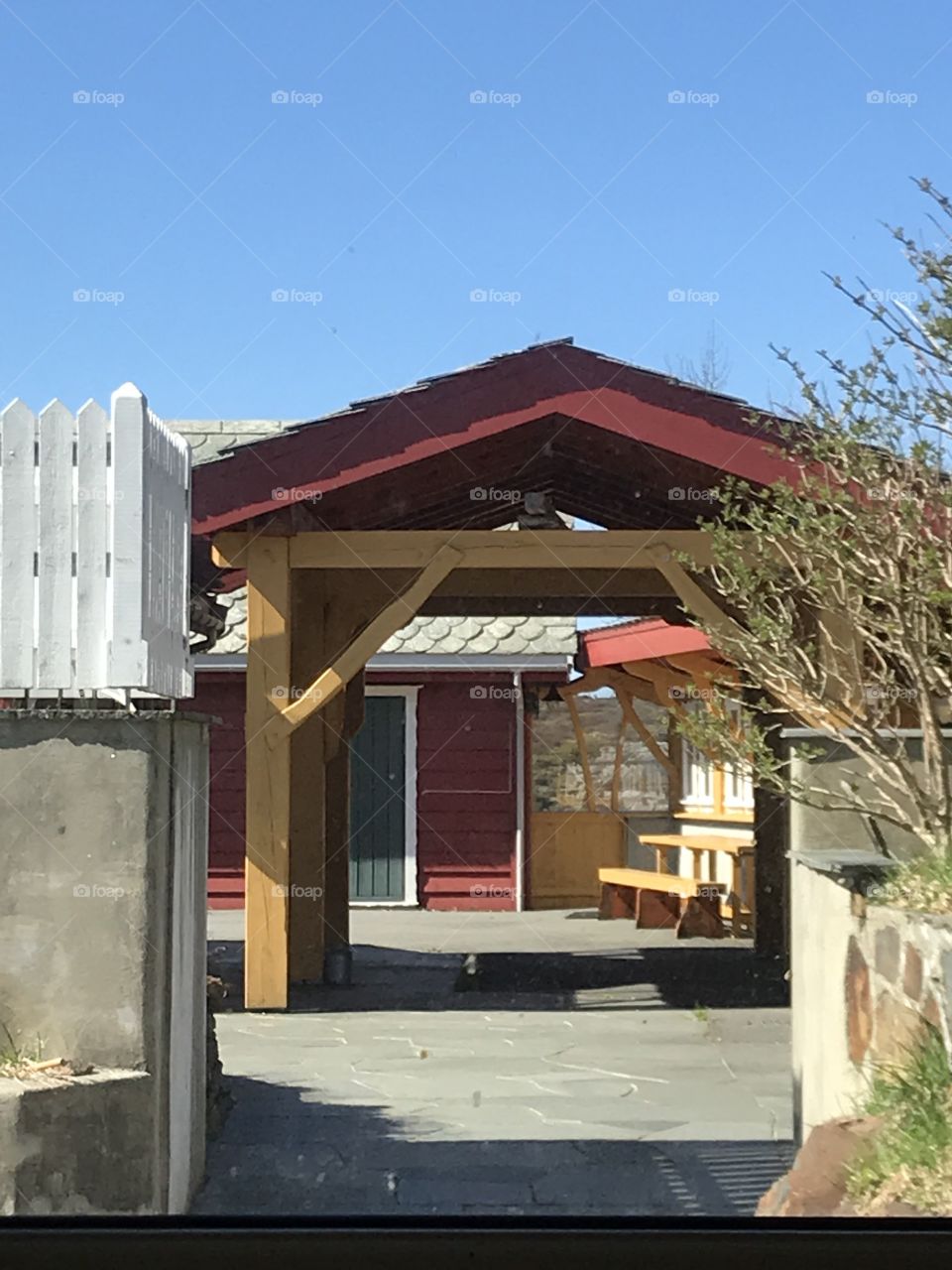 A cozy place to sit down and have a rest. A red roof to cover you for the rain, or to give you some shadow in the warm weather.