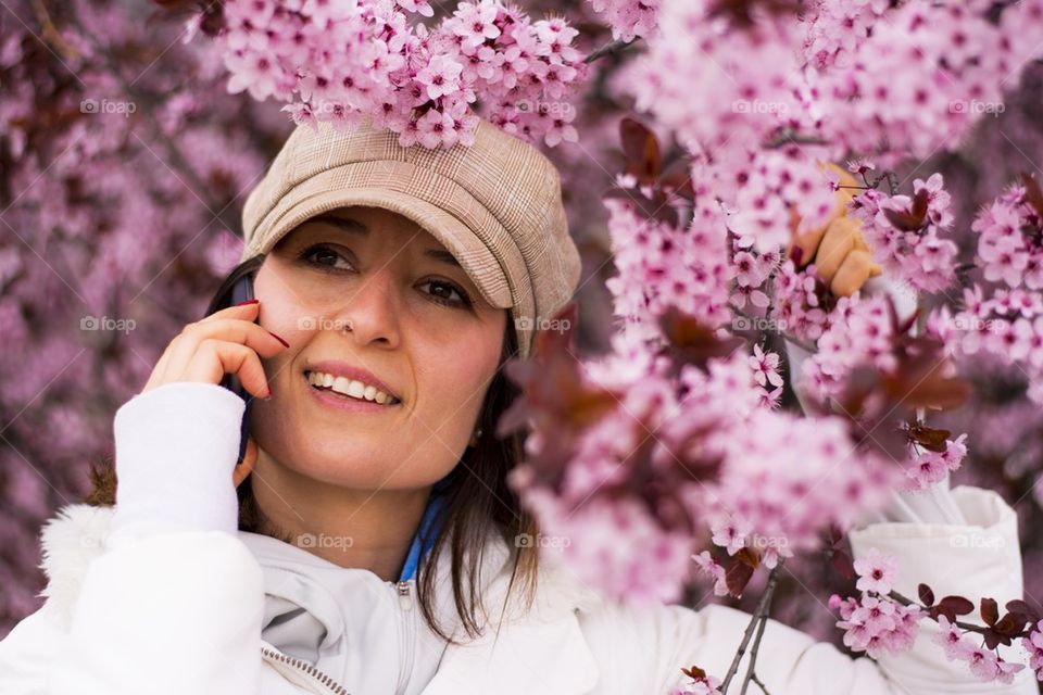 woman talking on the phone in spring blossom