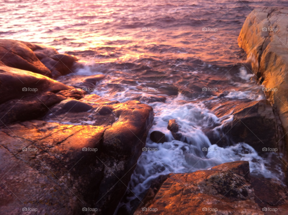 sunset sea rocks waves by haq