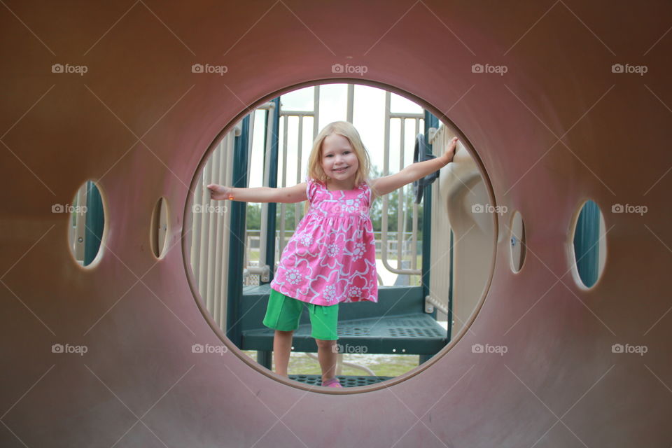 Little girl playing at a playground 