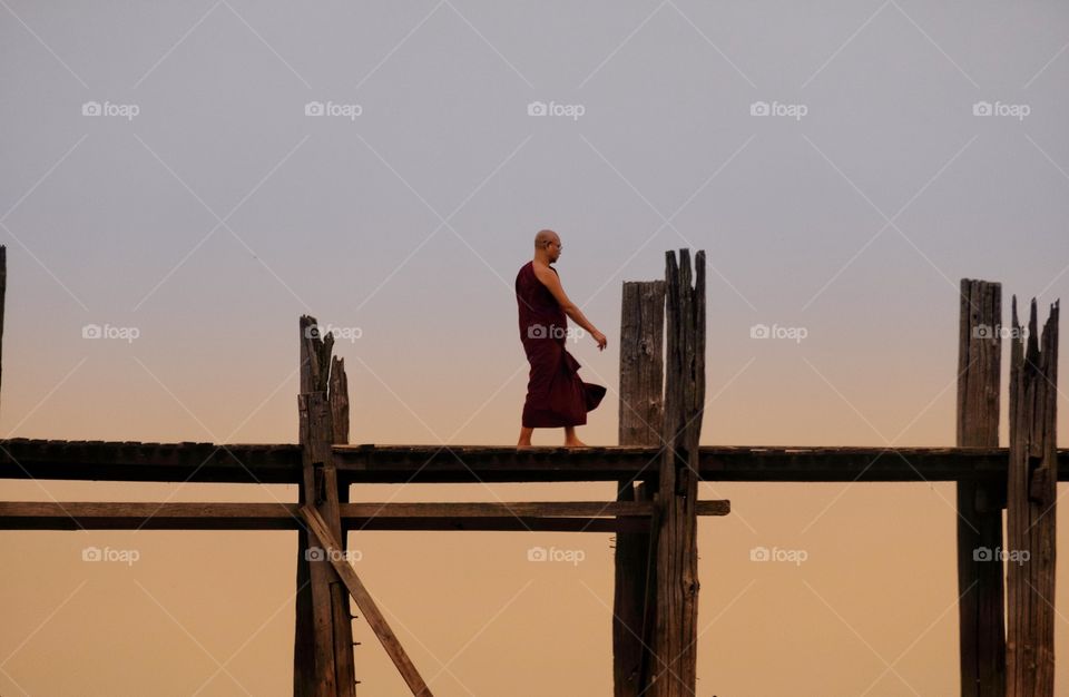 Local monk is walking on U Bein the longest wooden bridge in the world,Mandalay Myanmar 