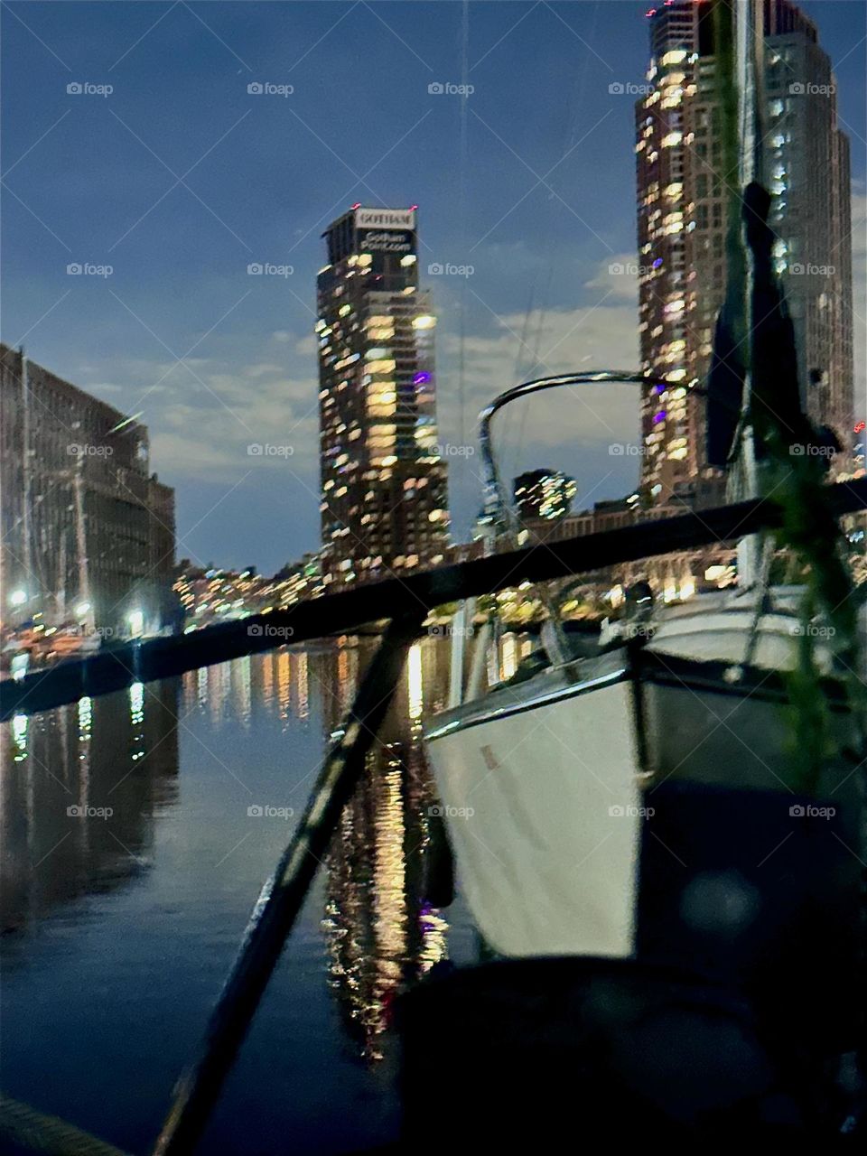 At night “Newtown Creek” by the “Pulaski Bridge” in LIC, Queens is illuminated by the moon, the electric lights of surrounding high rises in LIC and “Greenpoint”, Bklyn and their reflections in the “East River”. 2024. Hypnotic Productions