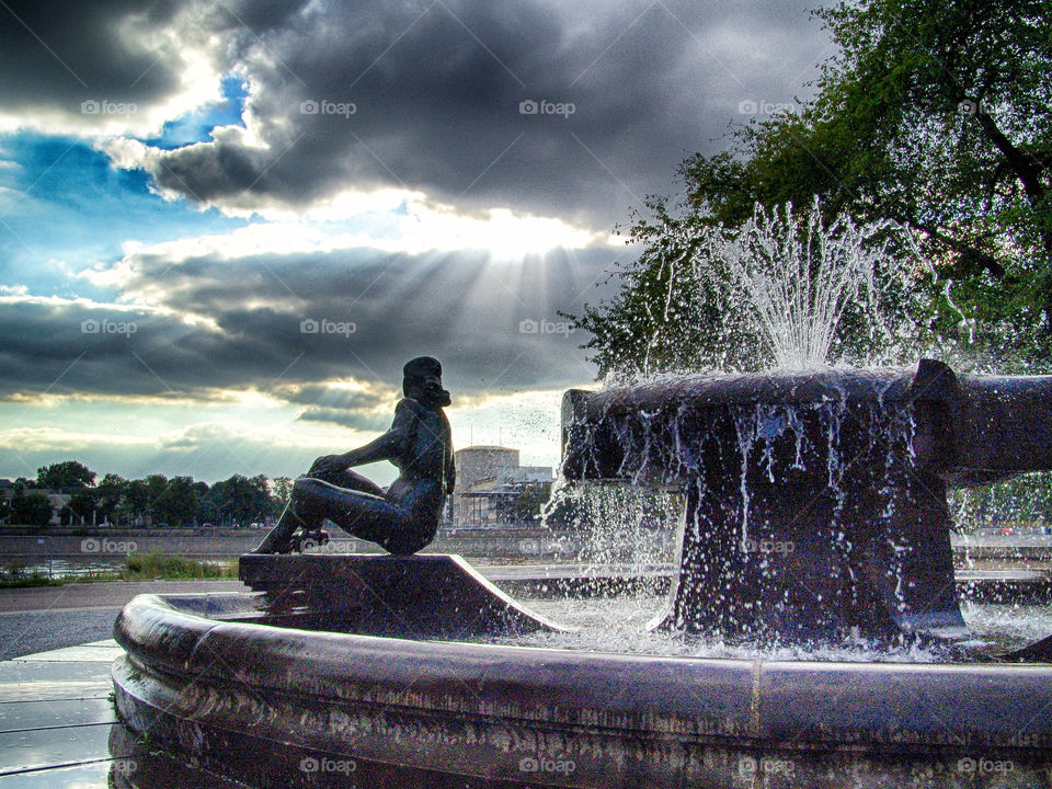 sculpture in front of dramatic sky