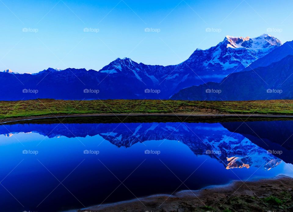 morning sunrise over snow capped mountains