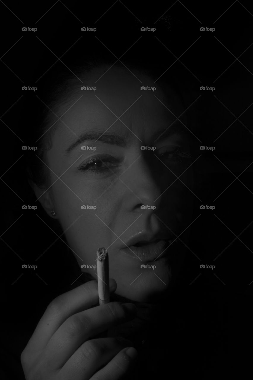 Portrait of woman smoking cigarette