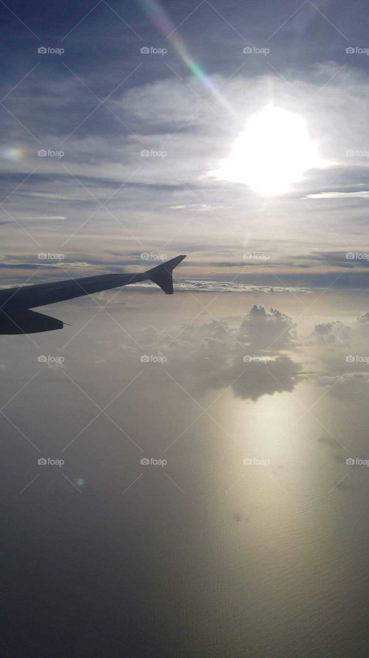 An overview shot of a calm ocean and skies of my flight to the Carribean island of Nassau.
