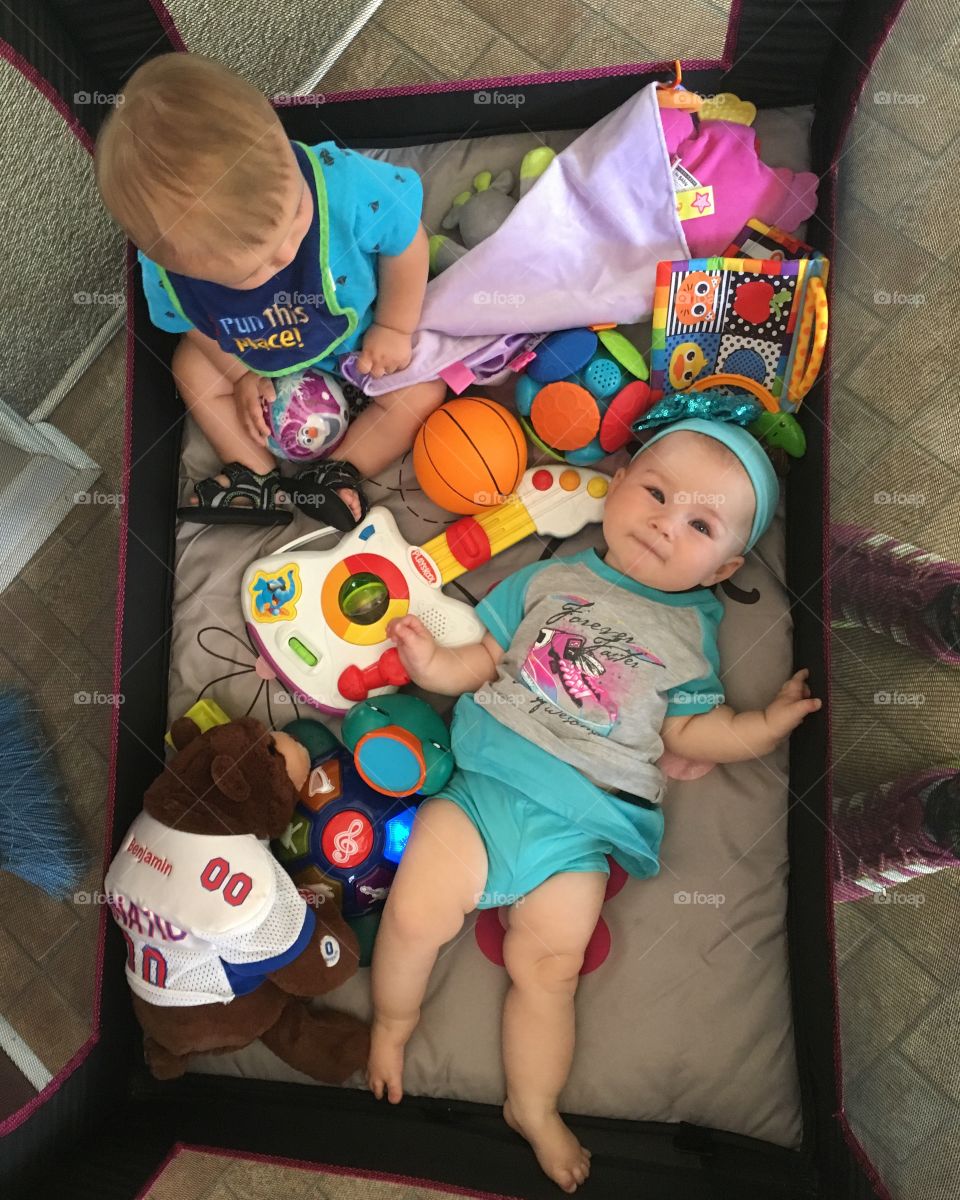 High angle view of siblings with toys