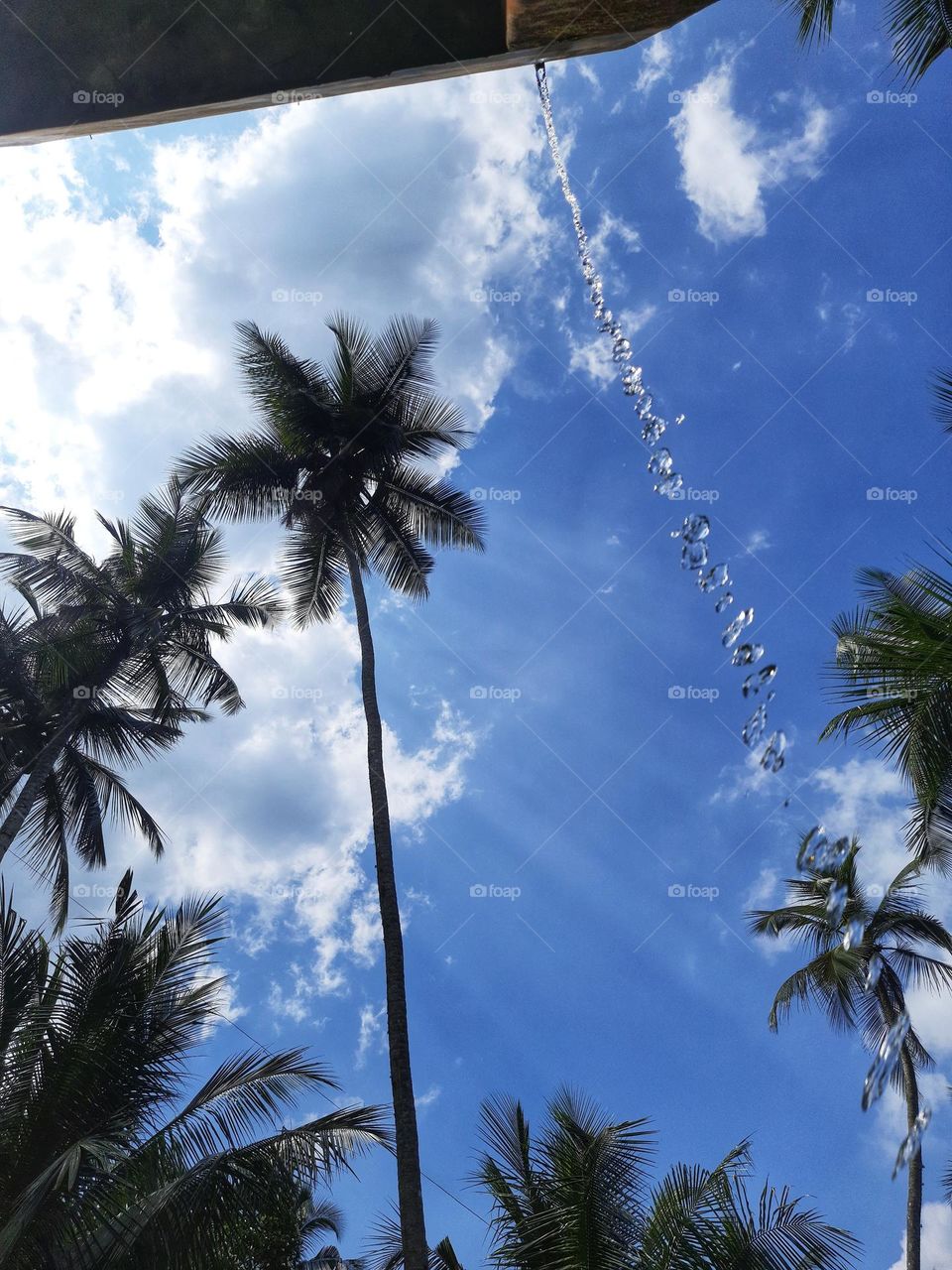 photo of overflowing water in a tank full of water and beautiful blue sky in sri lanka