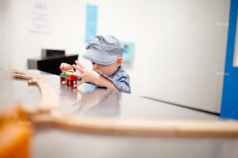 Toddler playing with a train set