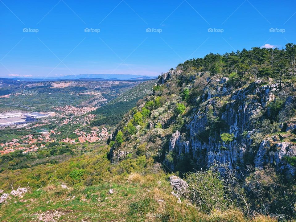 Scenic view of green hills against blue sky and Adriatic sea in Slovenia coast. Spring time