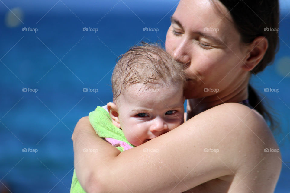 Mother carrying baby outdoors