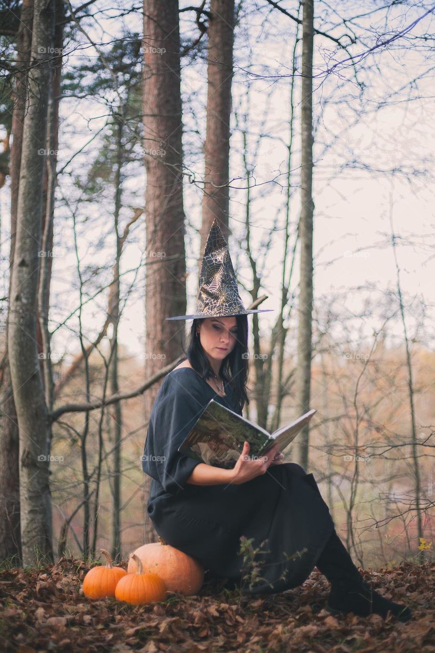 Witch reading a magic book