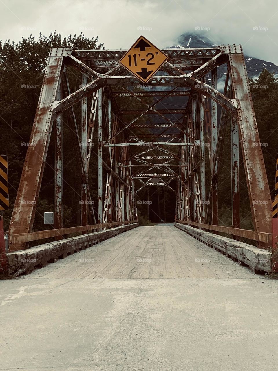 A vintage photo of an old wooden bridge in the backwoods of the Alaskan Frontier.