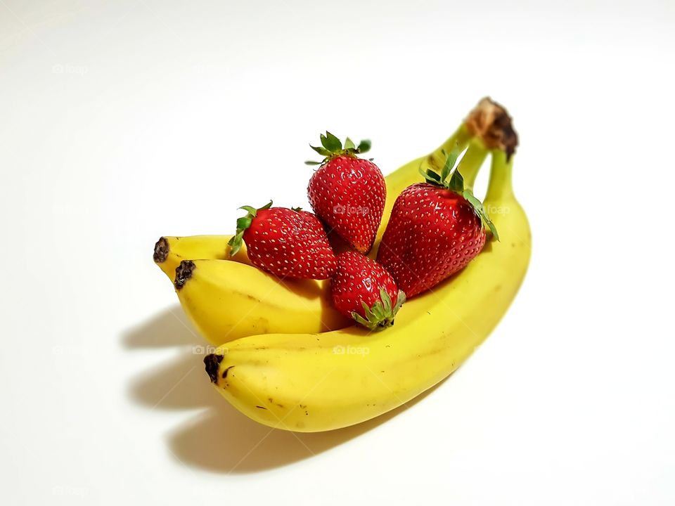 Bananas and strawberries hug. Concept of healthy lifestyle made by delicious fruits.