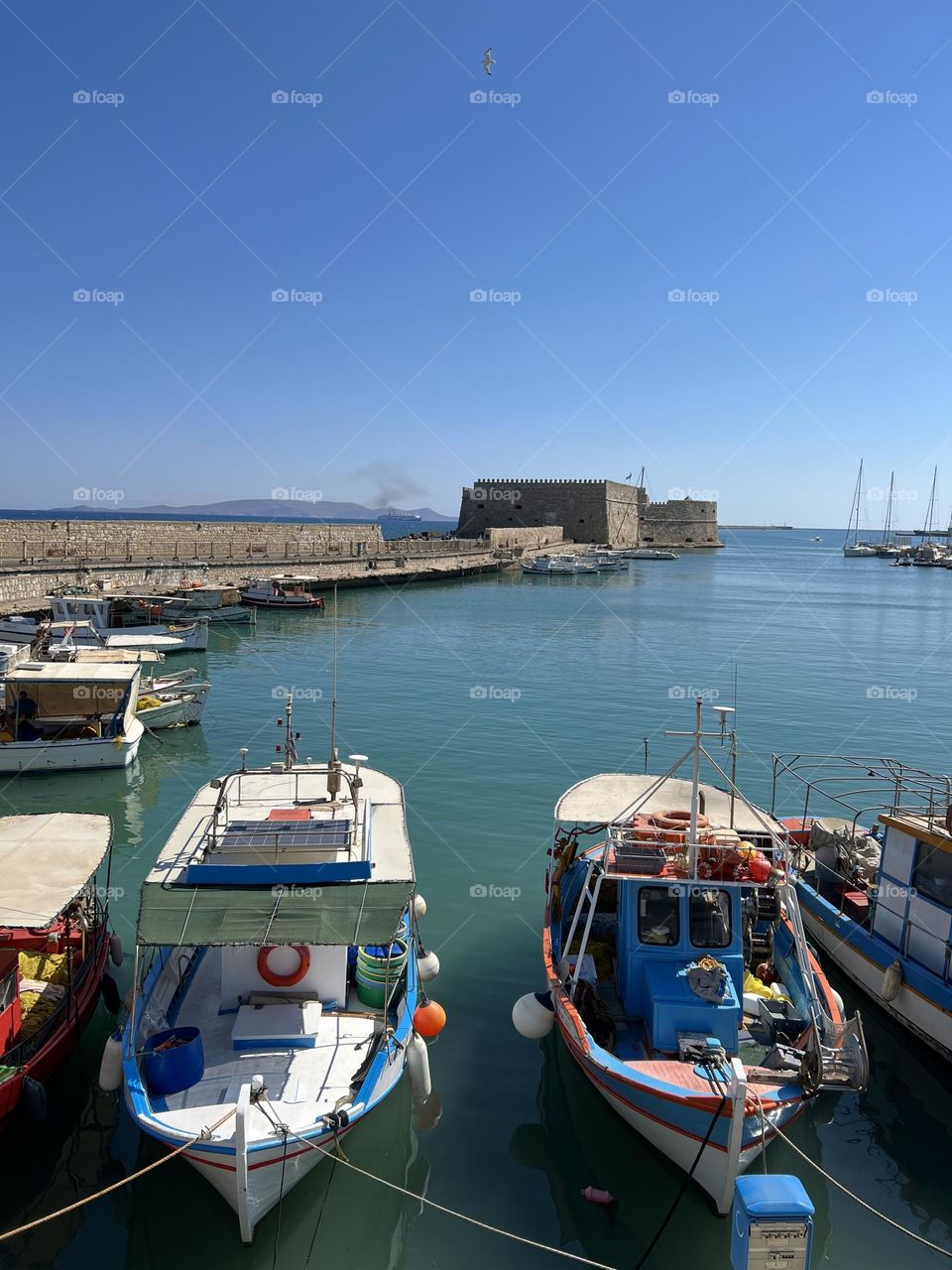 Two boats in Venetian port in Crete Greece 