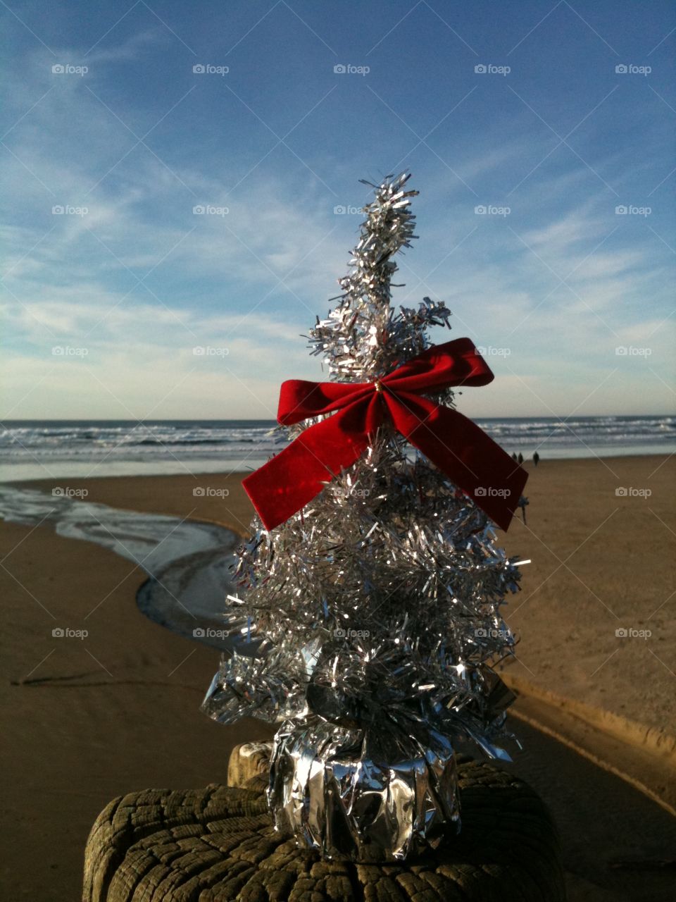Christmas on the Beach. Portable Christmas tree atop a deck post on Nye Beach in Oregon.