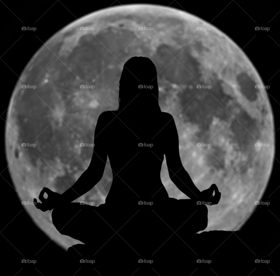 Rear view of a woman meditation in front of moon