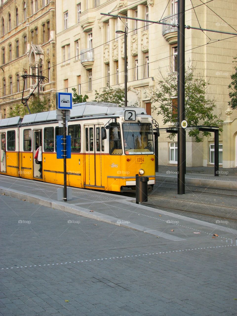 Yellow tram in Budapest. Yellow tram in the center of Budapest on a stop.
