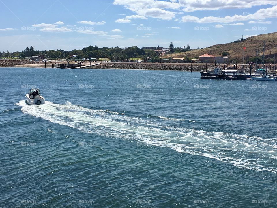 Speedboat running in ocean harbour 