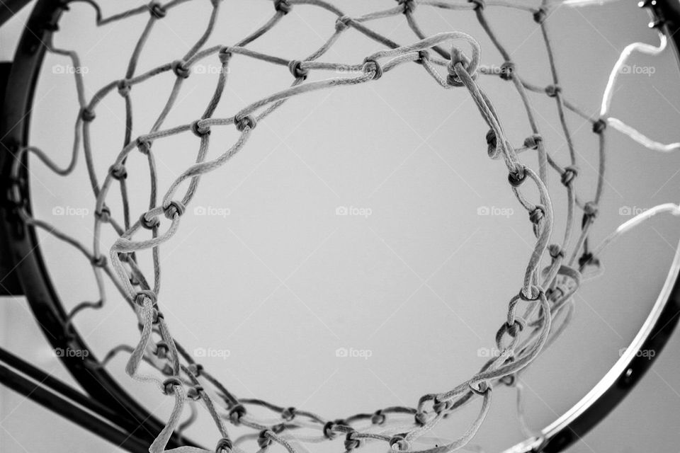 Looking up at a basketball net, waiting for the rebound in basketball game, net perspective shot, basketball net from below, beneath the basketball net 