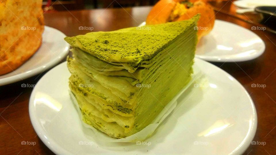 A matcha cake standing out from the test.