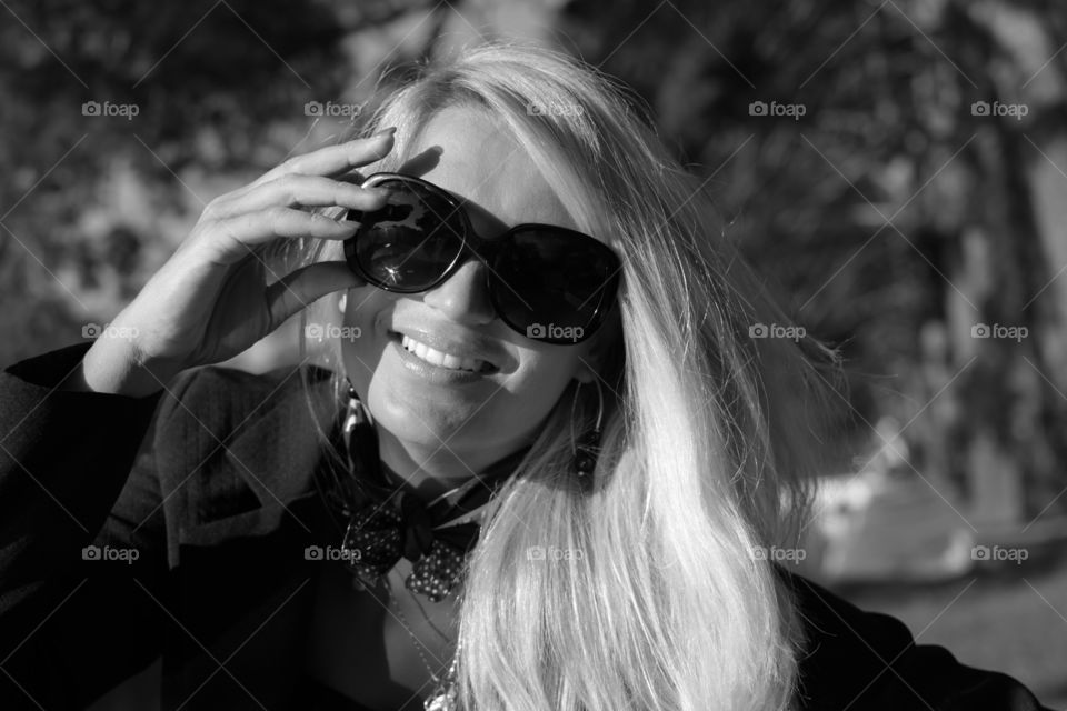 Portrait of smiling woman wearing sunglasses