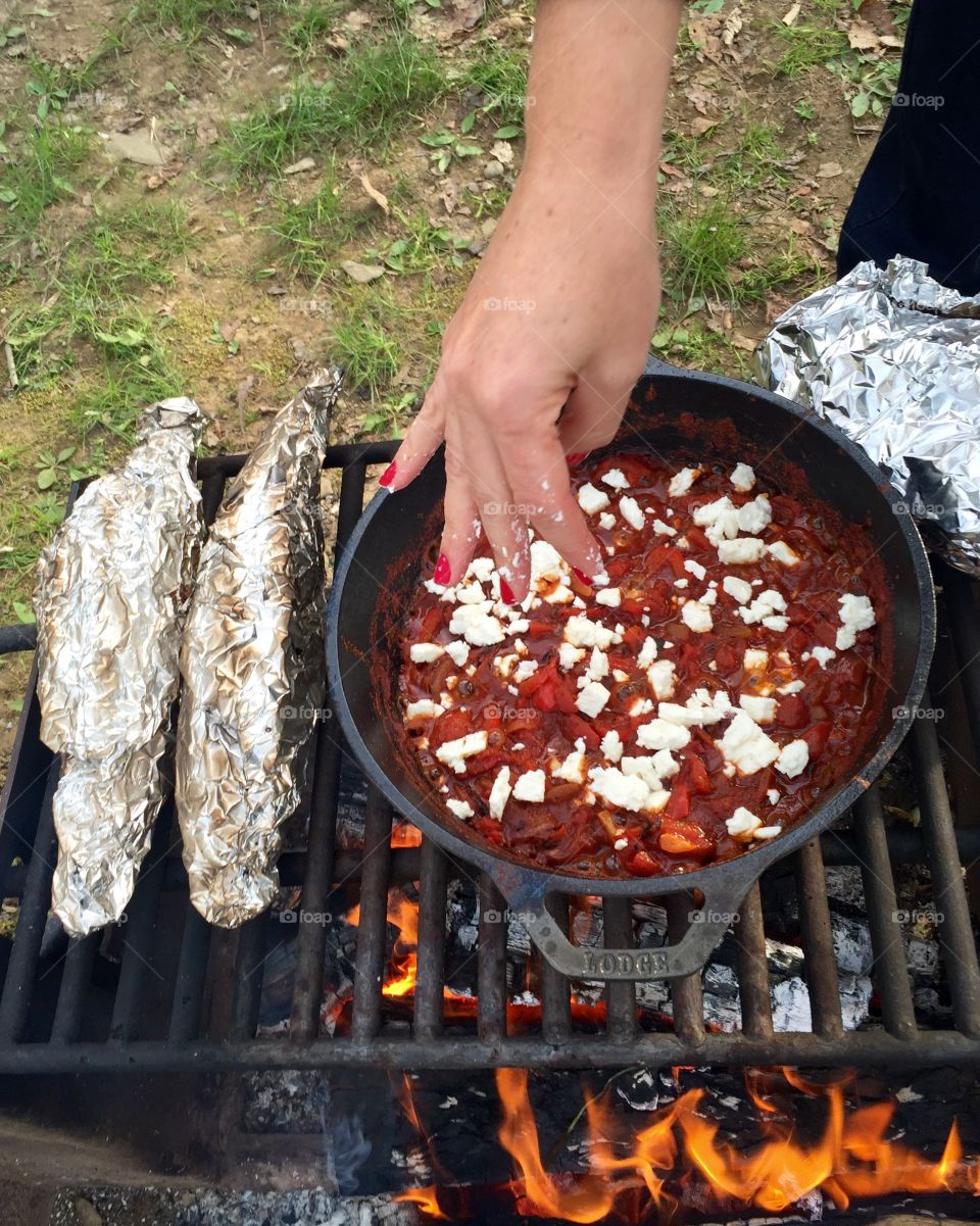 Feta on the shakshuka in the fire