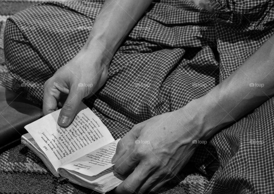 A man’s reading chanting book in the temple